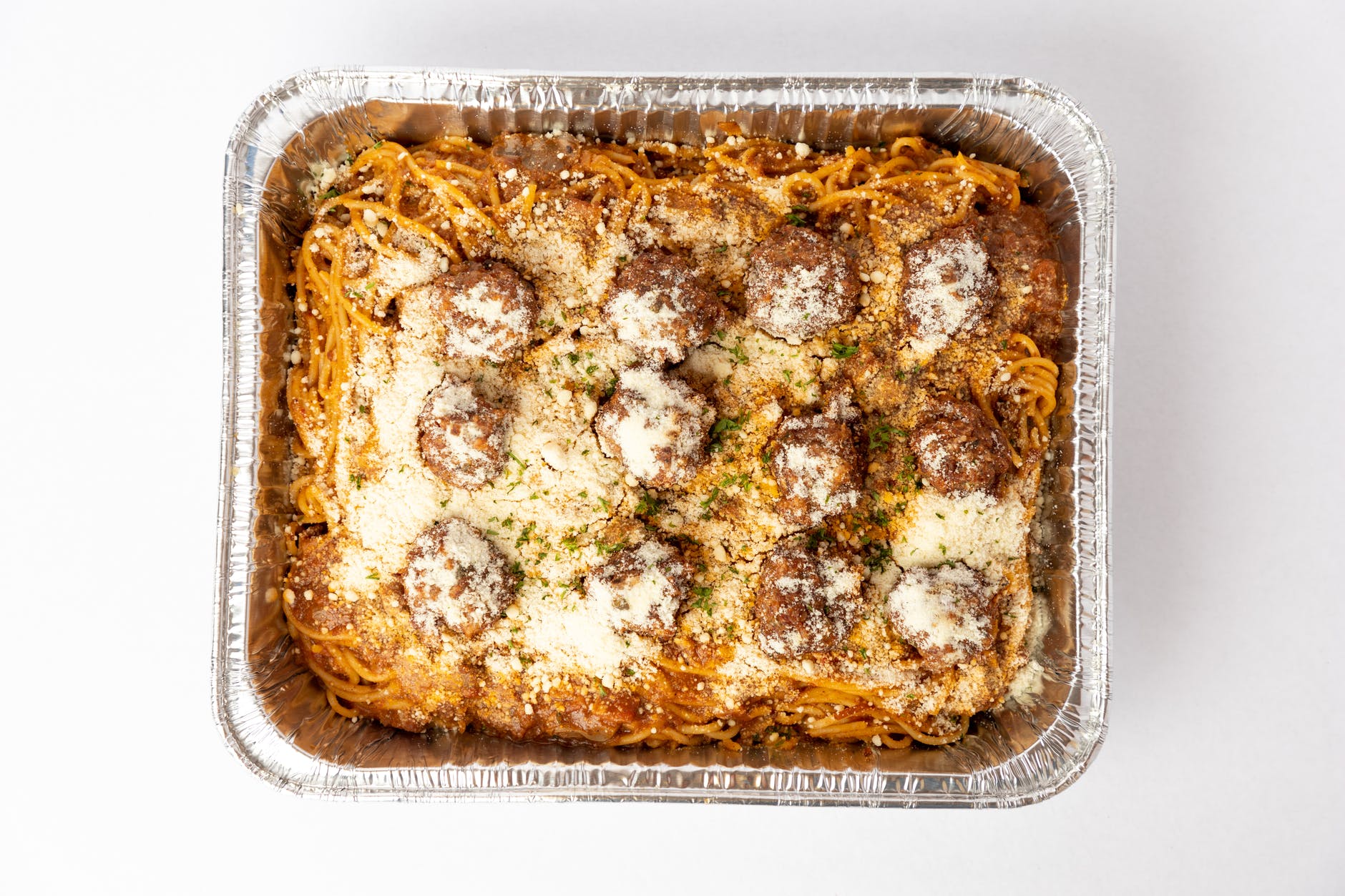 spaghetti with meatballs on aluminum tray