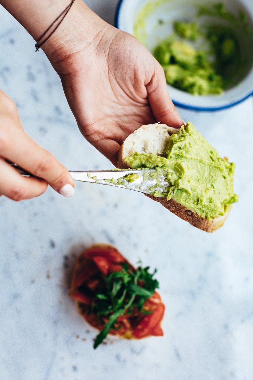 person holding green and white vegetable