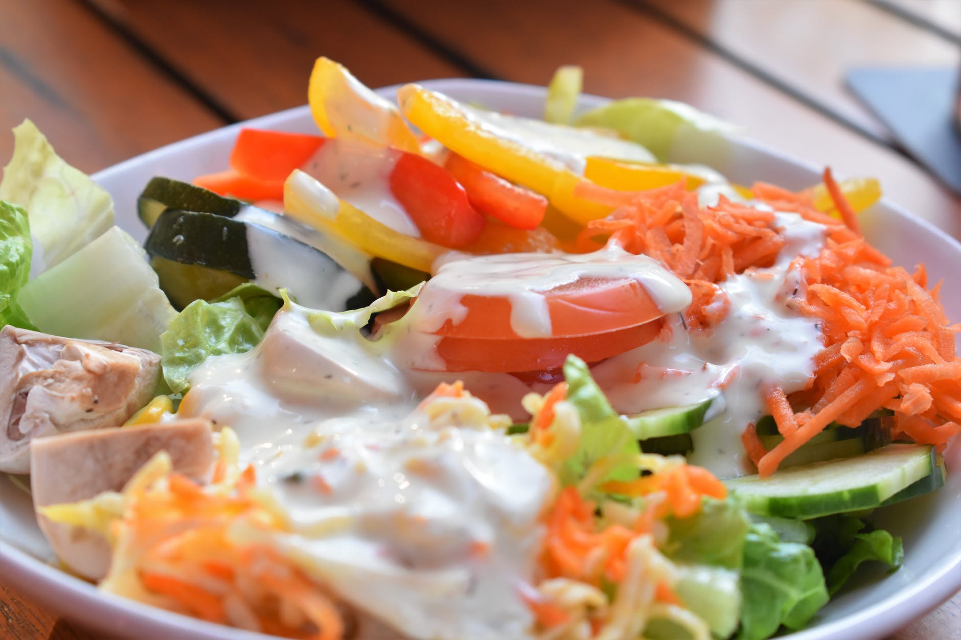vegetable salad covered with white dressing