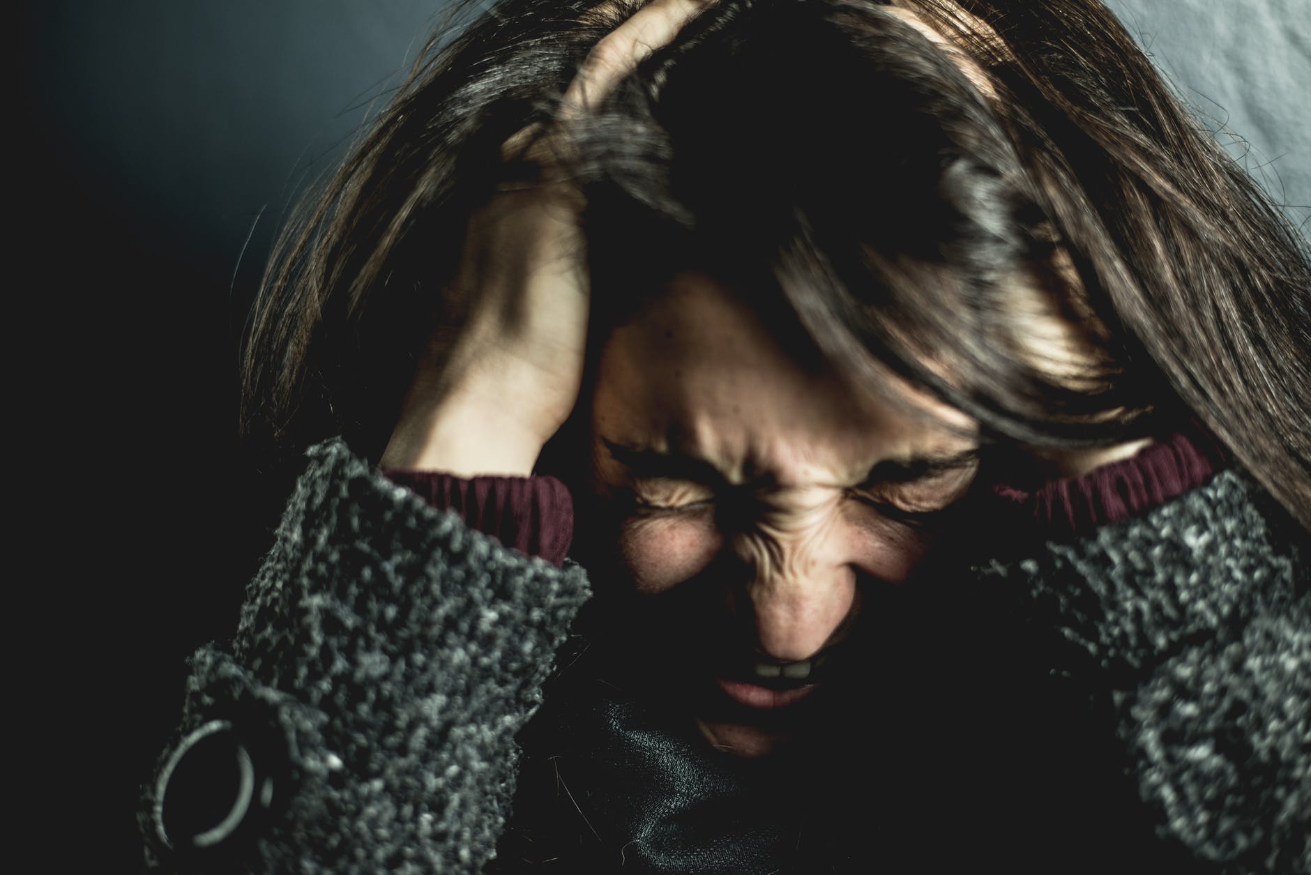 woman holding her head feeling stressed